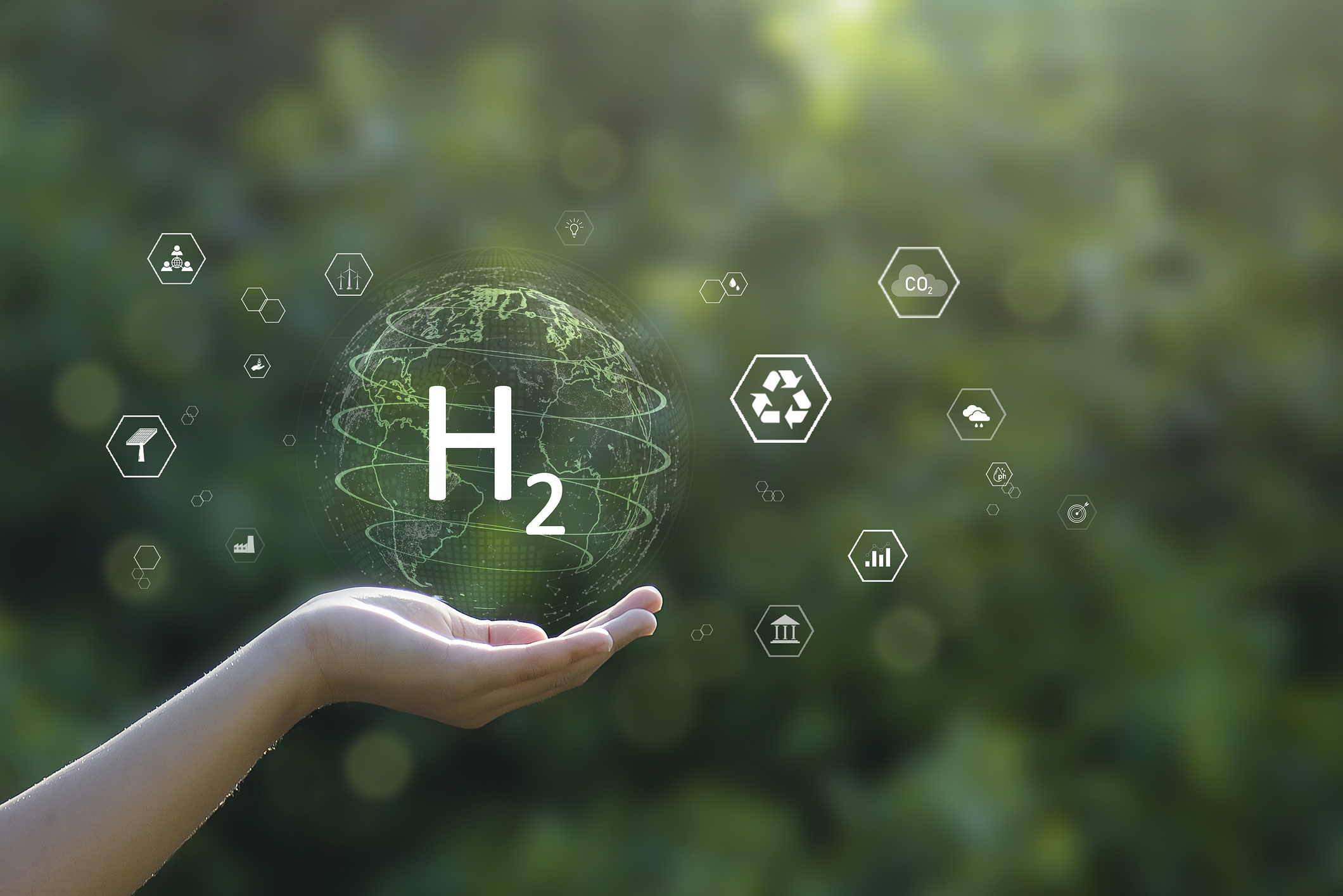 Illustration einer Hand, die ein Symbol für Wasserstoff hält
